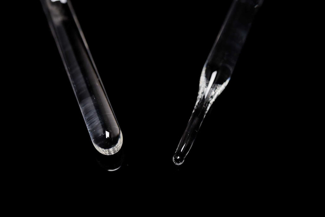 ROOR Glass Wand with round and pointed end tips on black background.