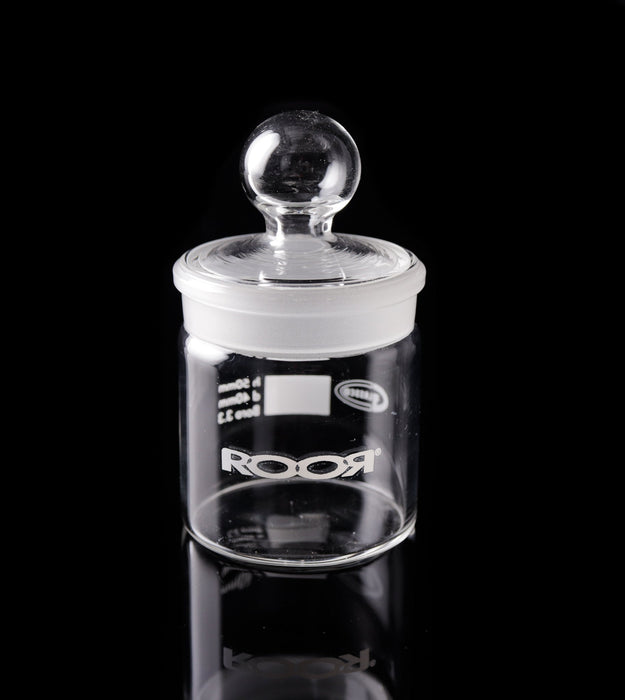 ROOR Glass Jar with collectible glass lid on black background.