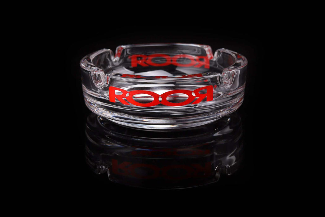 ROOR Collector Glass Ashtray with red decal on a reflective surface.
