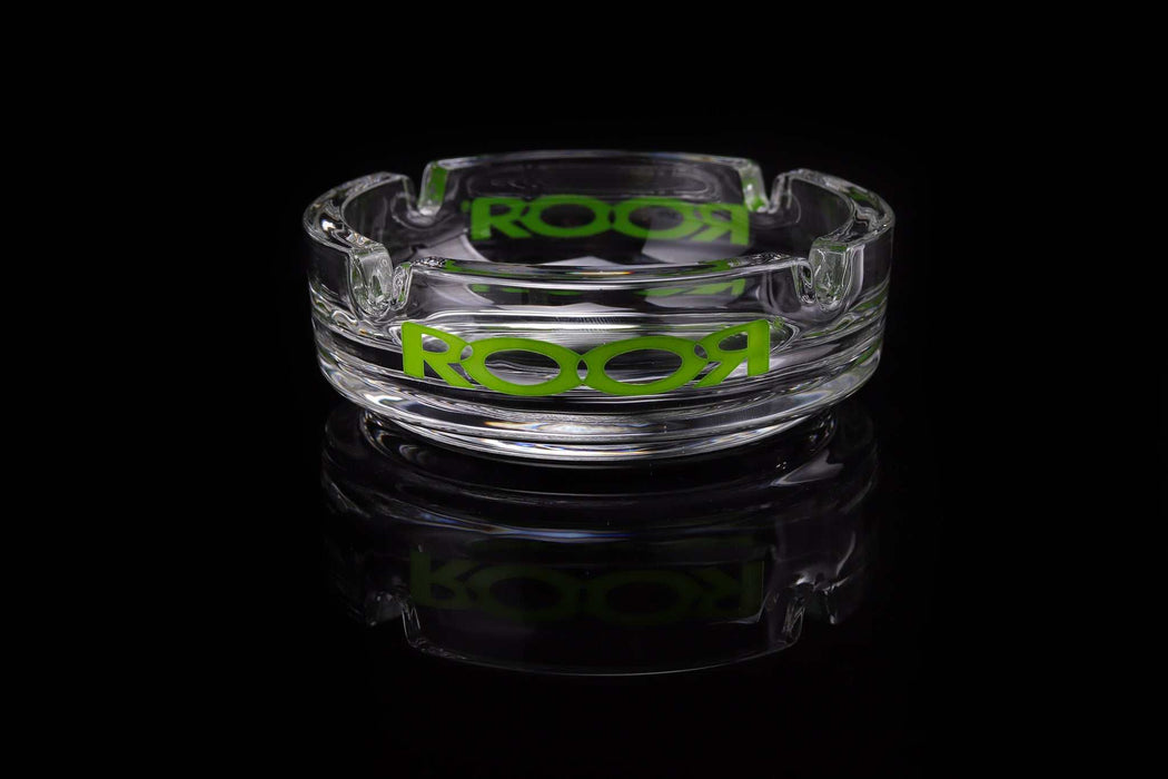 ROOR Collector Glass Ashtray with green decal reflecting on black surface.