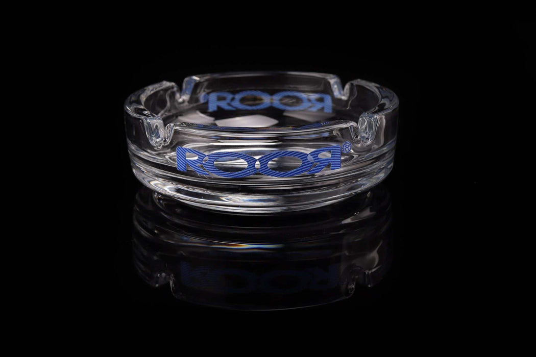 ROOR Collector Glass Ashtray with blue decal on reflective black surface.