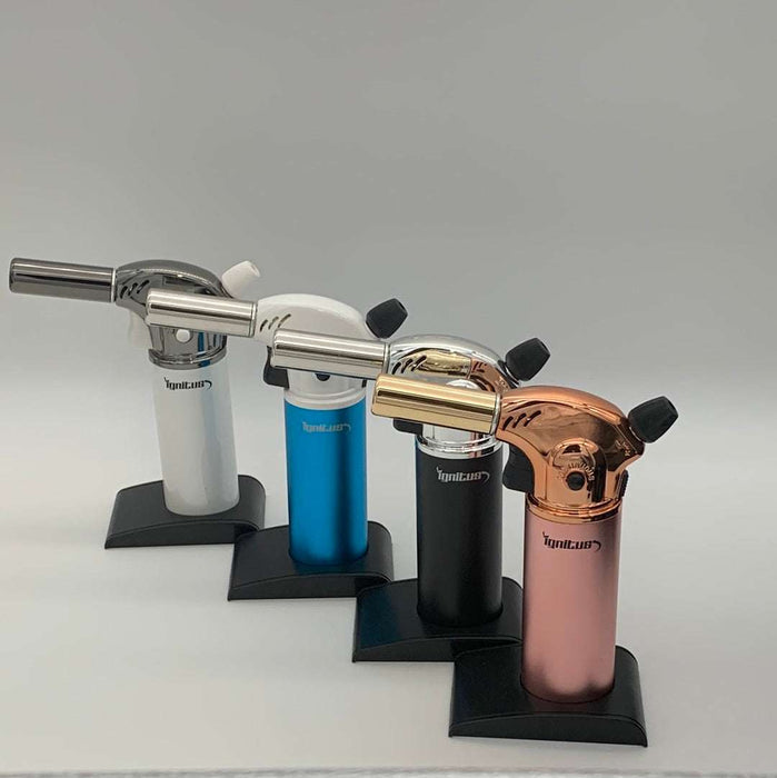 Assorted Ignatus Magnum Torches in white, blue, black, and copper finishes displayed on stands.