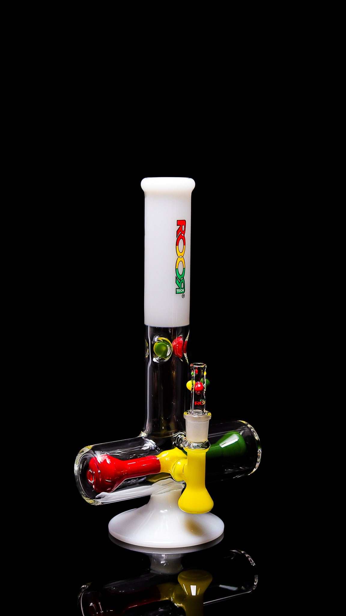 ROOR® Tech 12" Mini Inline White Rasta Edition water pipe with colorful accents on black background.