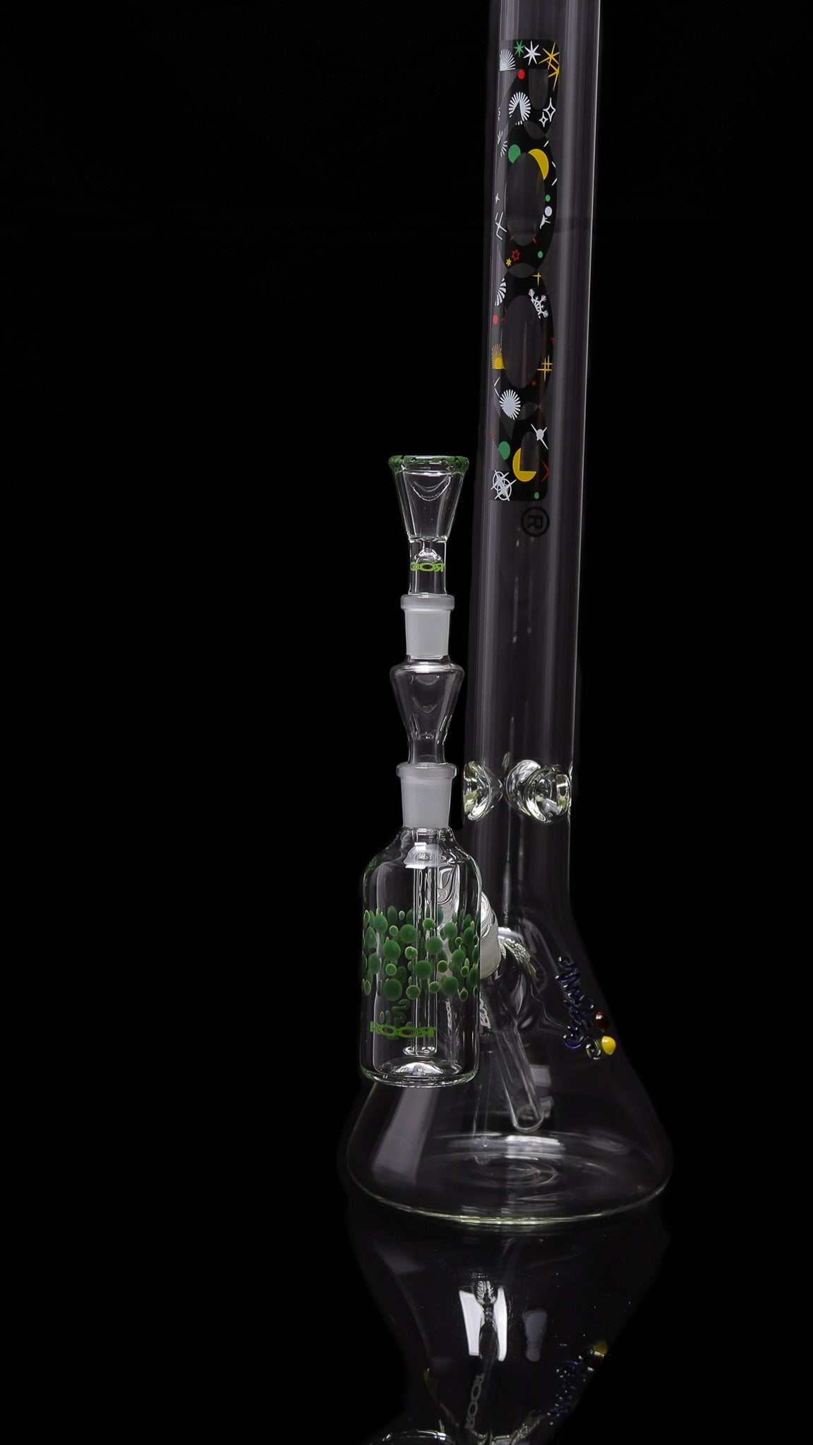 ROOR® Classic Ash Catcher 14.5mm joint with green pearl dot design attached to clear glass water pipe