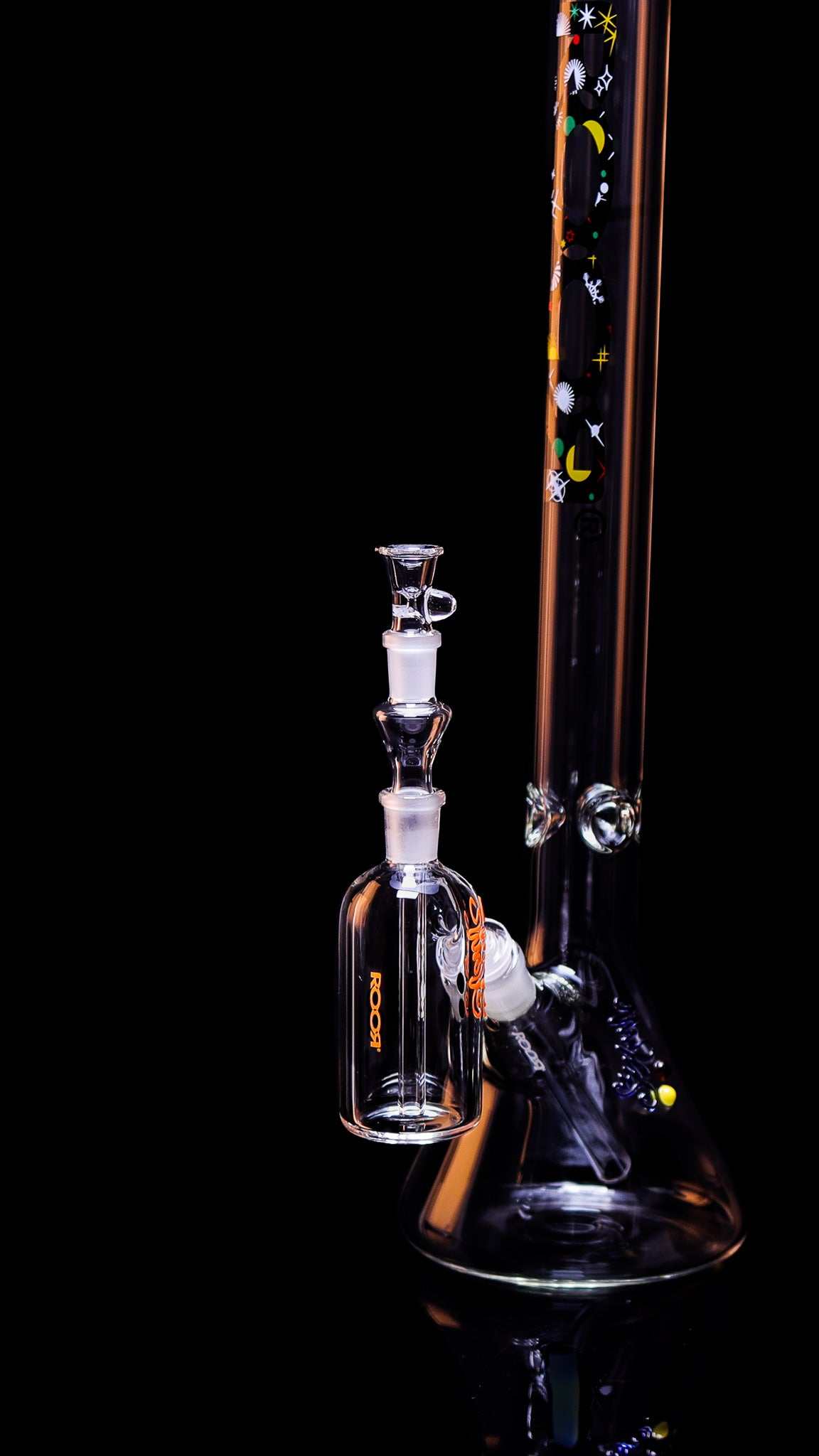 ROOR® Classic Ash Catcher 14.5mm Joint glass accessory with decorative decals attached to a glass bong.