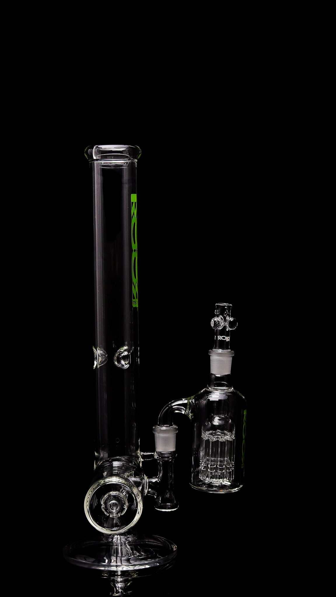 ROOR Tech 18-inch clear glass inline bong with green decal and matching 10-arm ashcatcher on black background