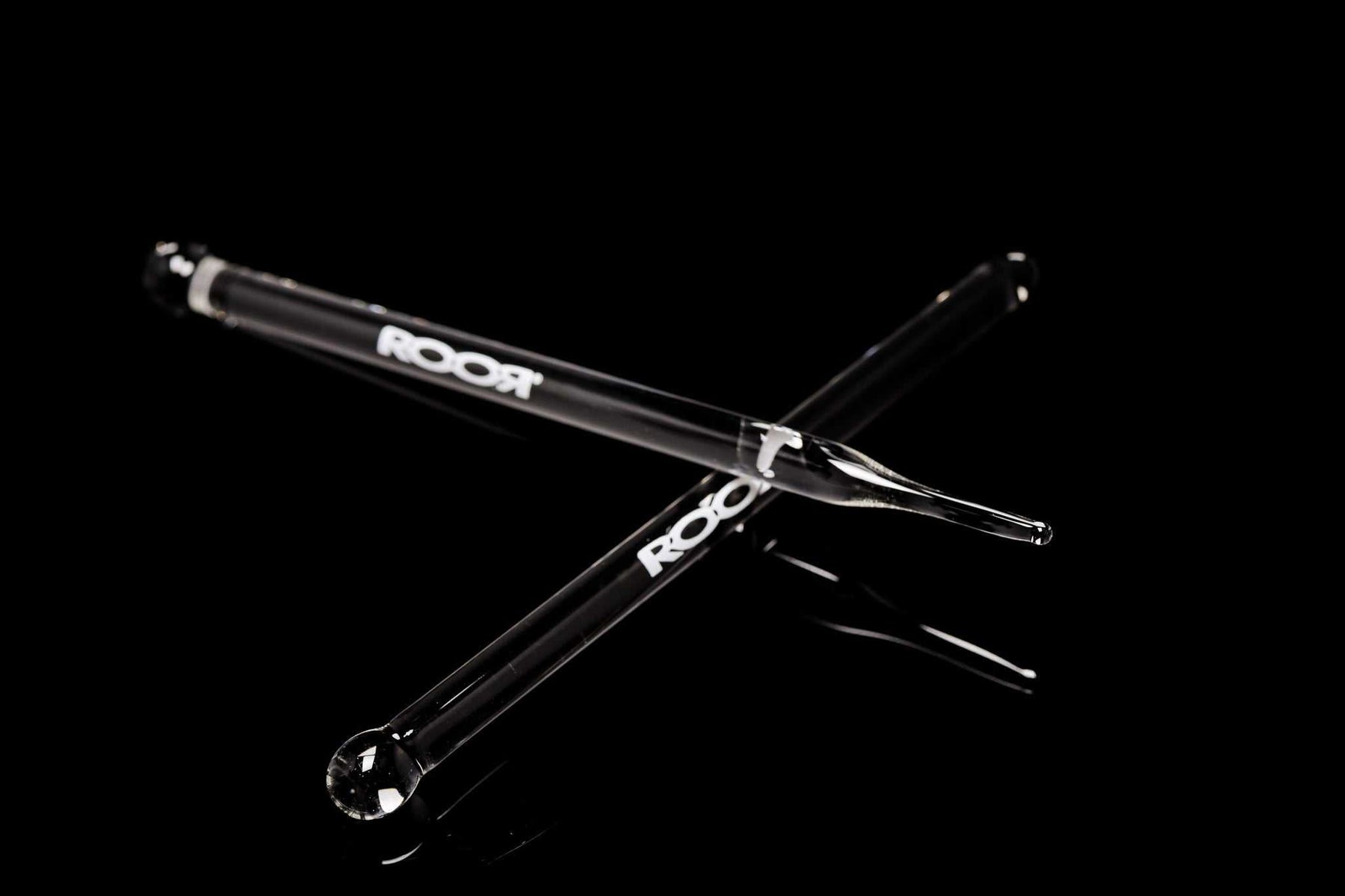 ROOR Glass Wand with choice of round or pointed tip on black background.
