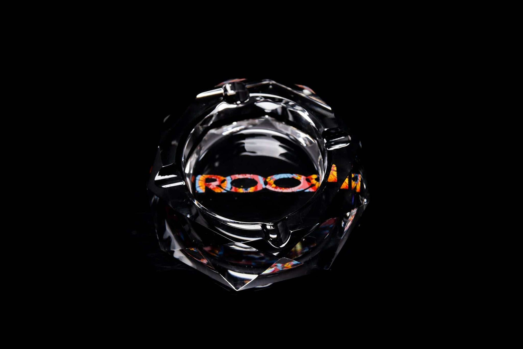 ROOR glass crystal cut ashtray with colorful decal on a black background
