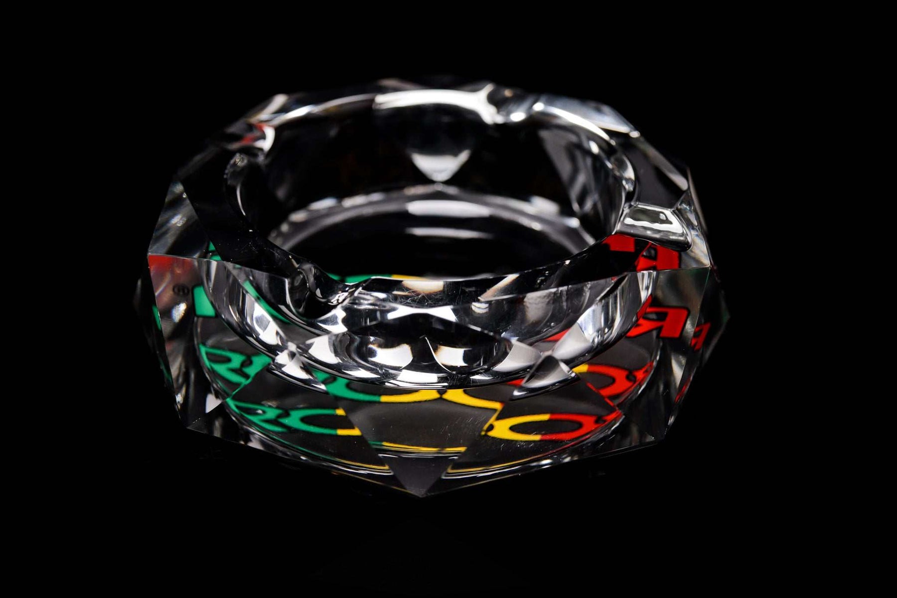 ROOR glass crystal cut ashtray with colorful decal on black background
