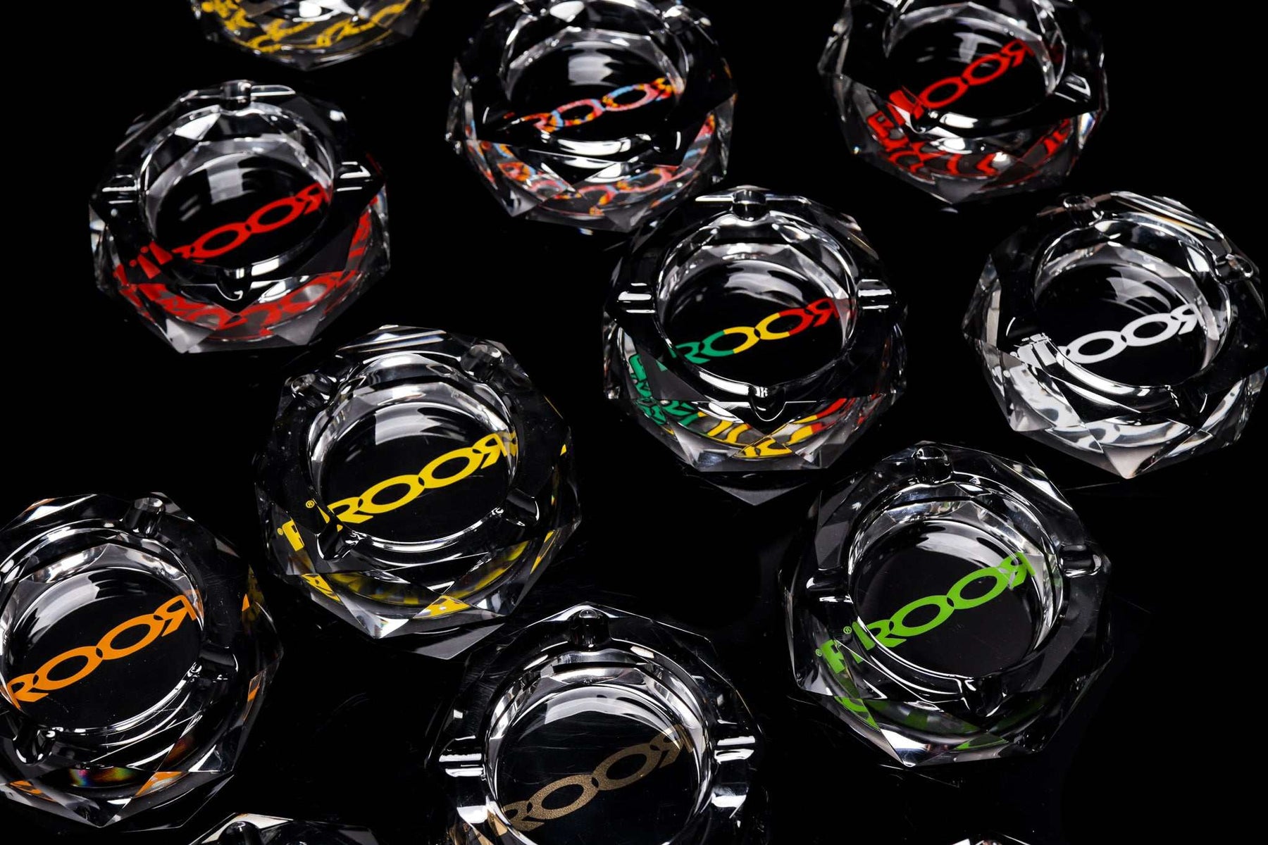 ROOR glass crystal cut ashtrays with colorful decals on black background