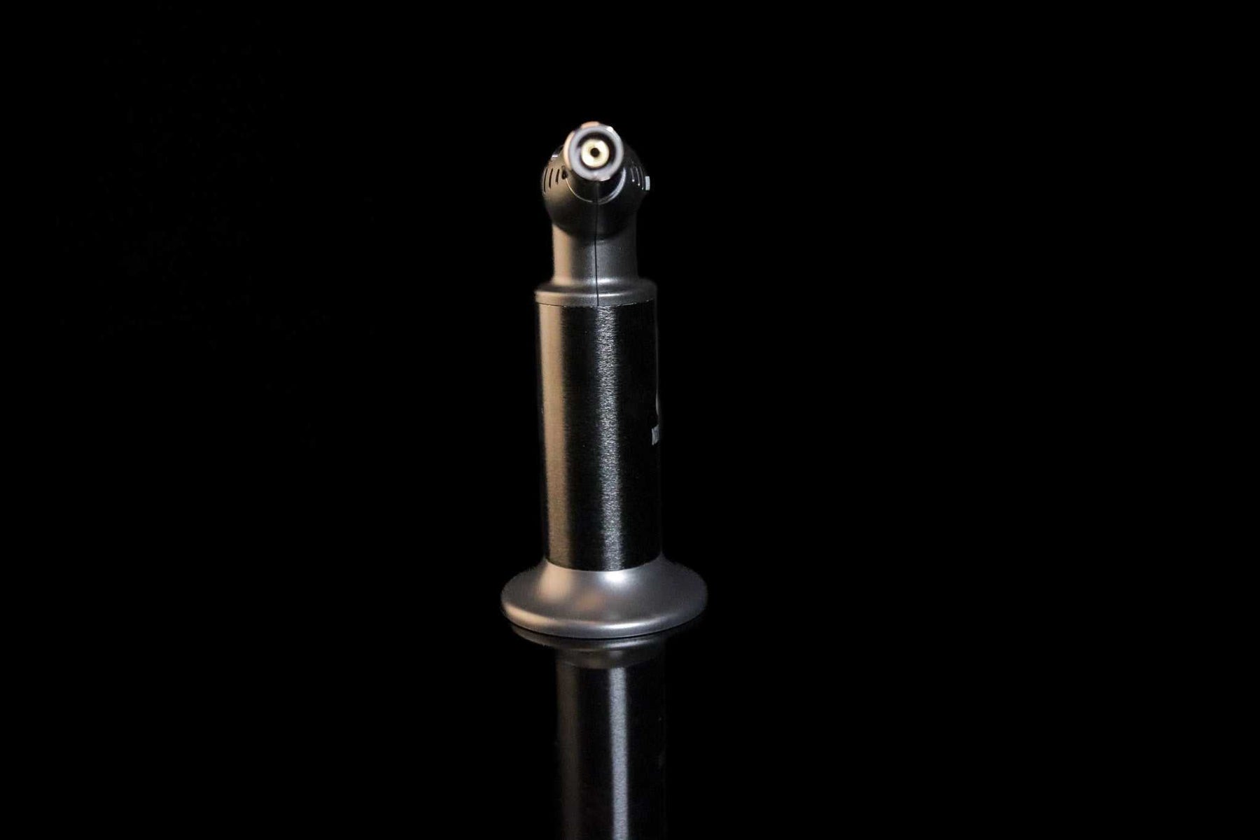 Newport Zero Jumbo Butane Torch standing on reflective surface with black background