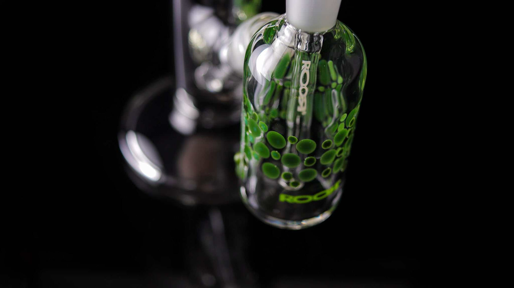 Close-up of ROOR Classic 14" Straight glass with green pearl dot design on a black background