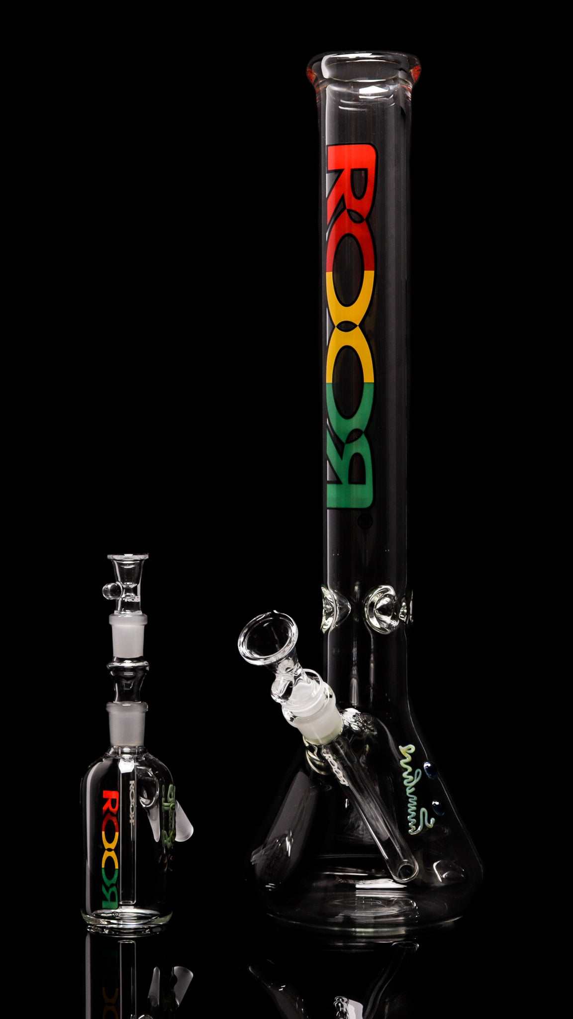 Exclusive ROOR 18” Beaker and 14mm Ashcatcher with RASTA label, crafted from German Schott glass, featuring ice pinches for cooler hits.