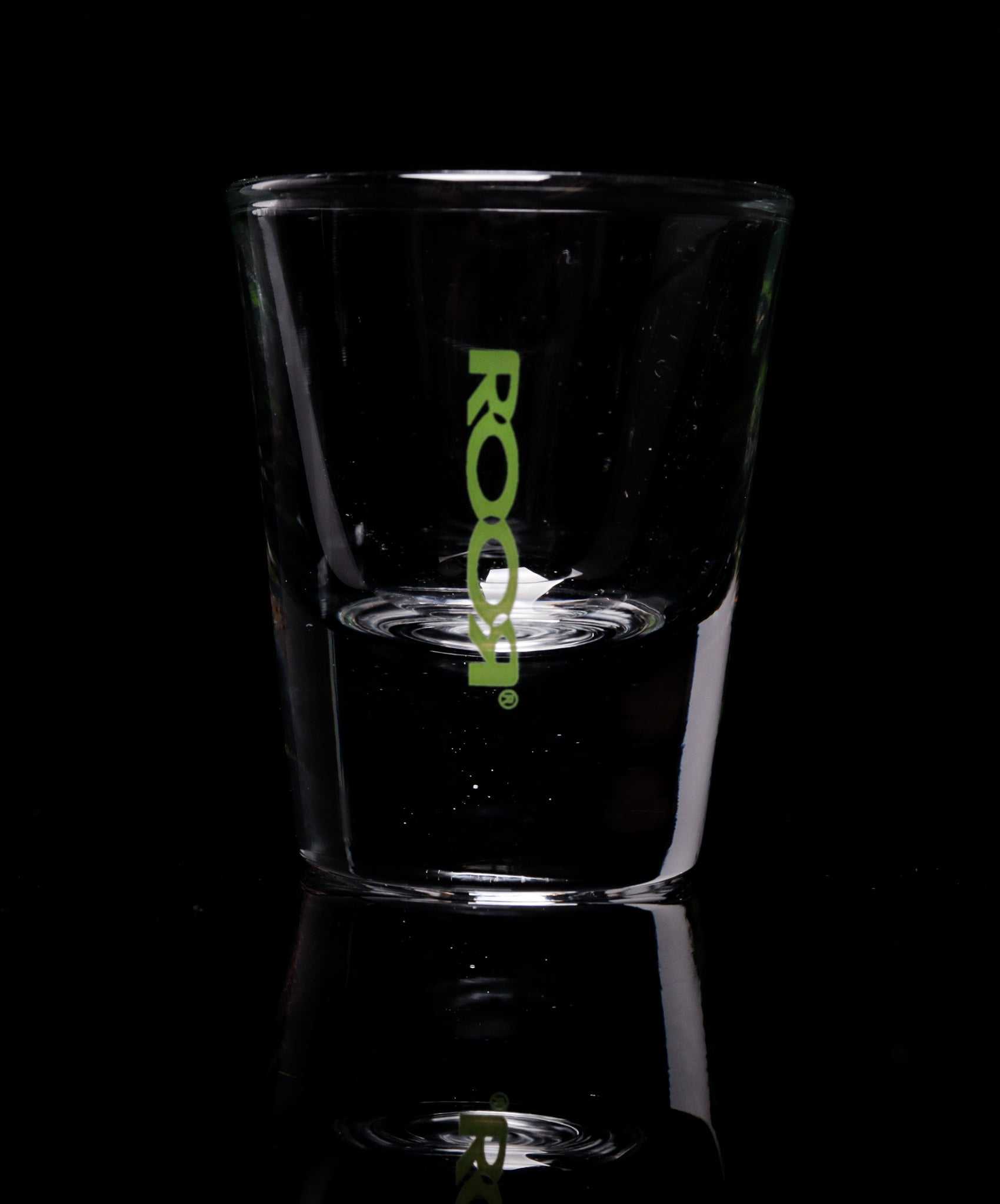 ROOR Shot Glass with thick clear base and green logo.