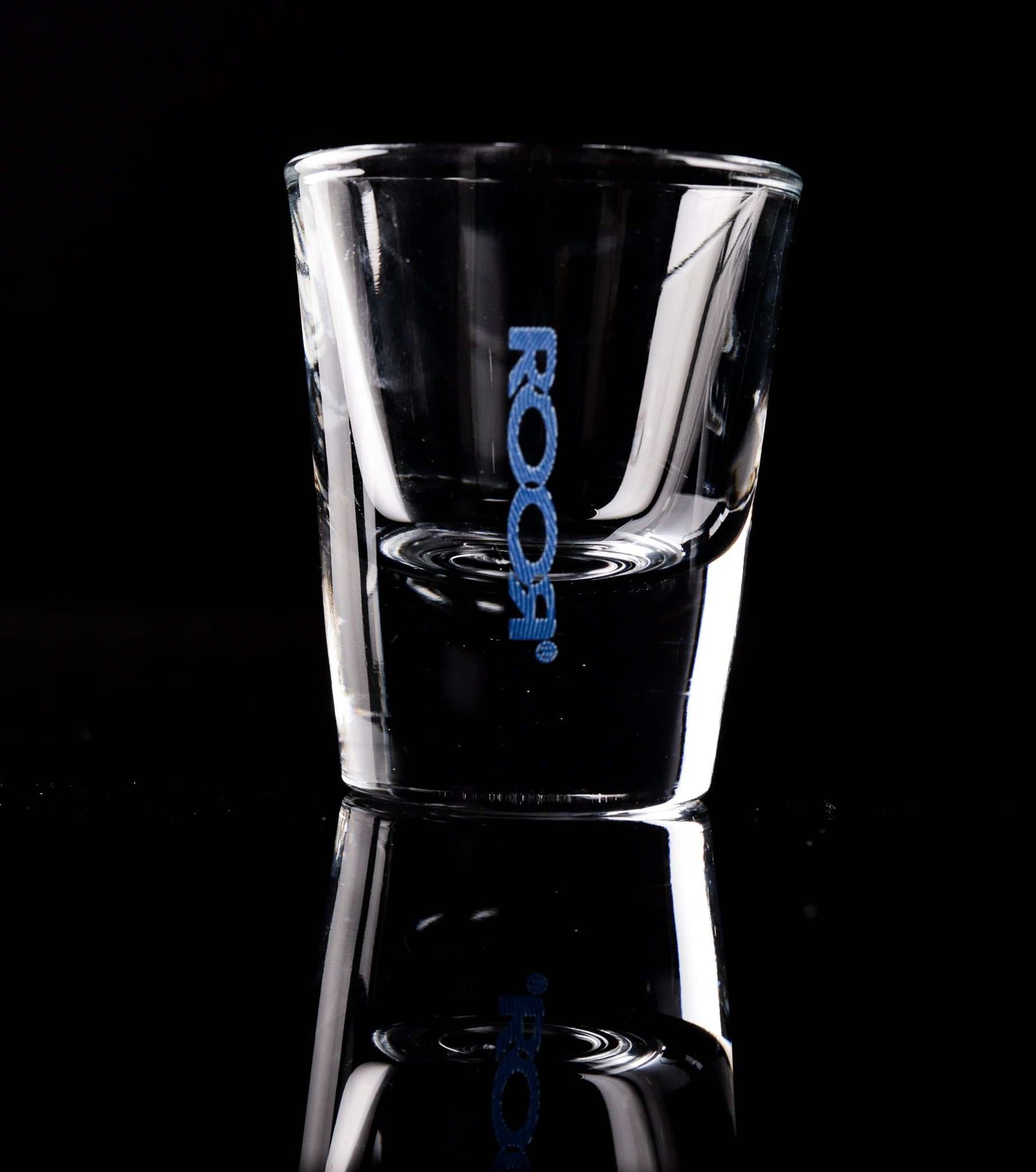ROOR Shot Glass with thick clear base and blue decal design.