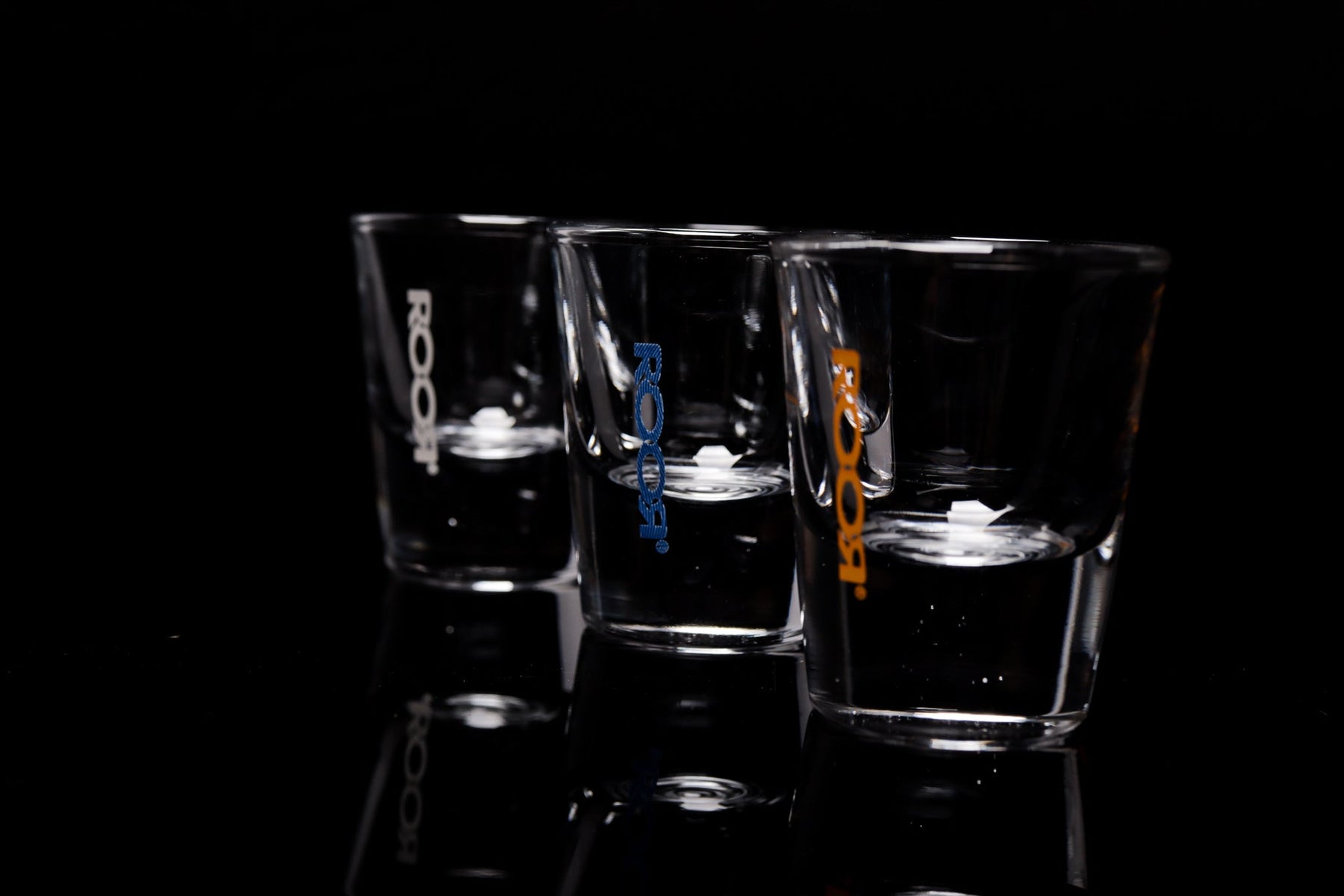 ROOR Shot Glass with thick clear base and assorted decal colors, 1oz capacity.