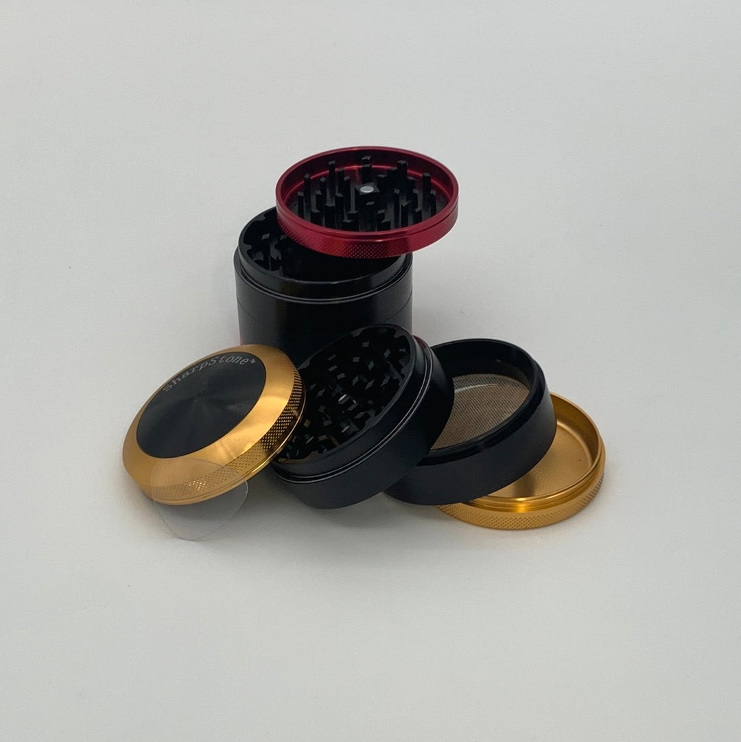 SHARPSTONE® HARD TOP 4 PIECE GRINDER - 2.5" in black and gold, showcasing durable aircraft-grade aluminum and sharp diamond cutting blades.