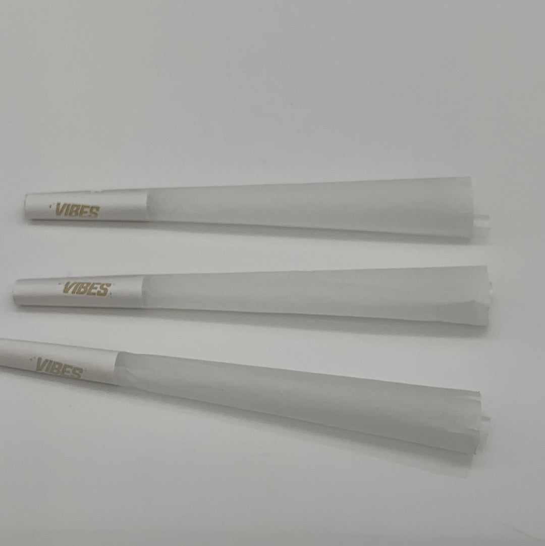 Three king size Vibes fine rolling paper rice cones arranged on a white background