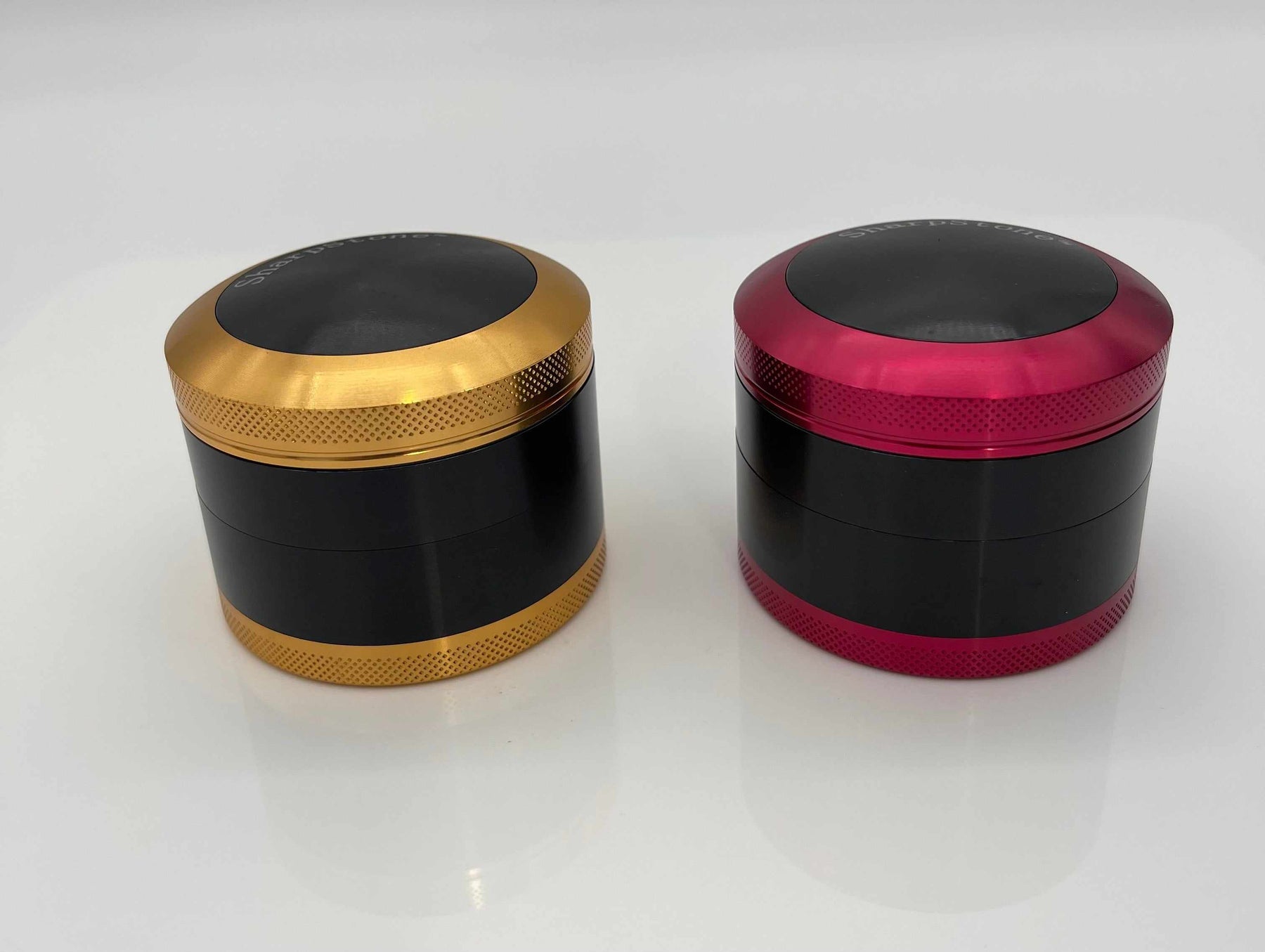 SHARPSTONE® HARD TOP 4 PIECE GRINDER - 2.5", gold and red anodized aluminum grinder with smooth finish and sharp diamond cutting blades.