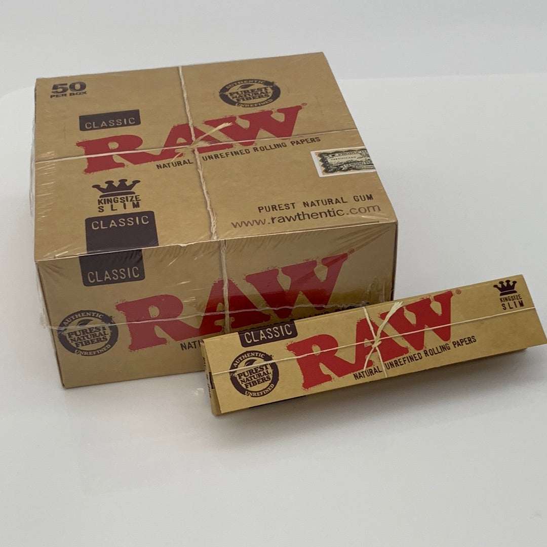 RAW Classic King Size Slim Brown rolling paper 4-pack with natural unrefined papers and purest natural gum shown with box and single pack