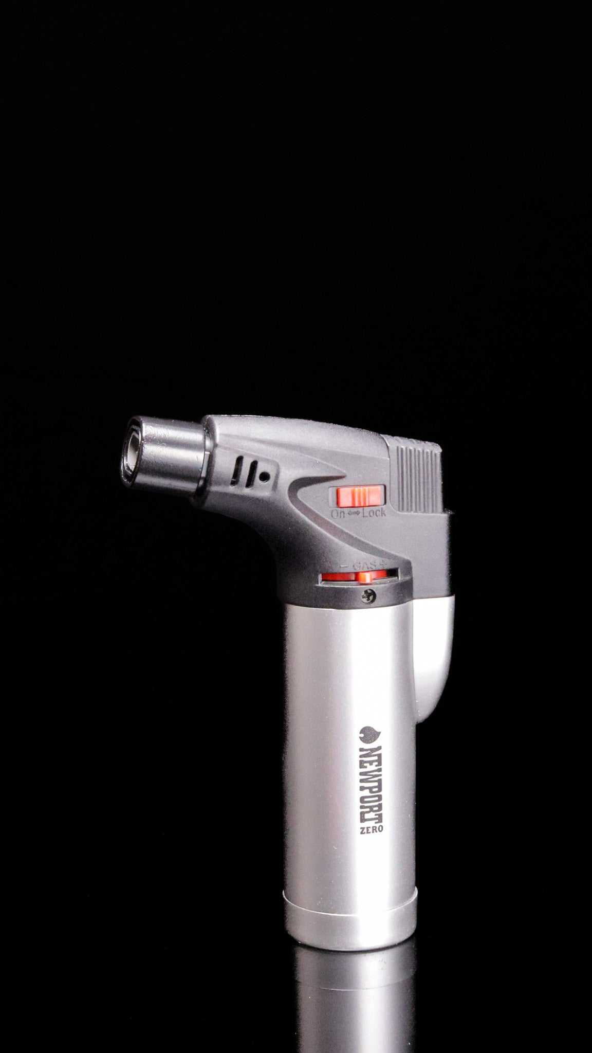 Newport Zero micro torch butane lighter with safety lock and flame jet switch on black background