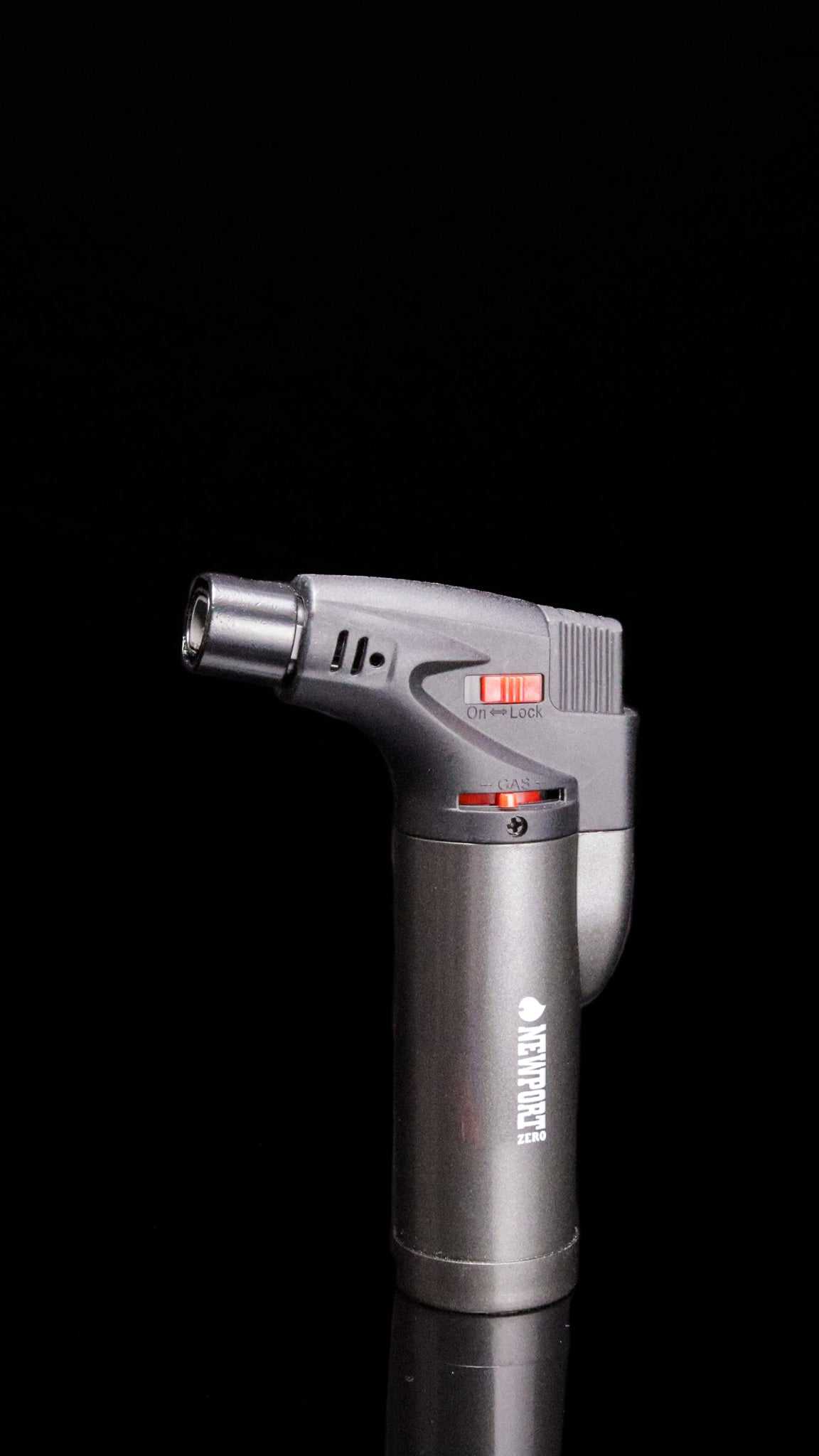 Newport Zero Micro Torch in silver with ignition and flame jet switch on black background