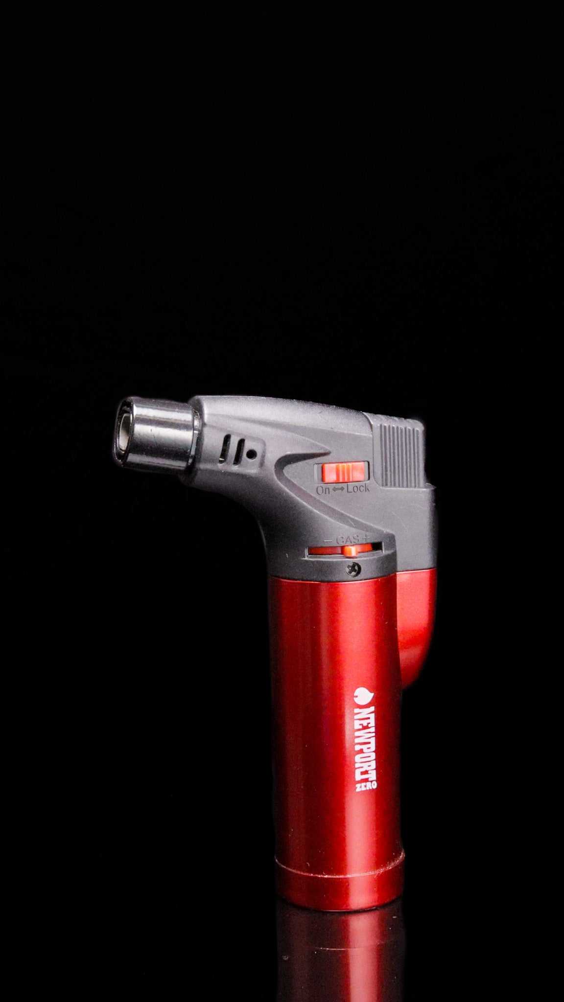 Red Newport Zero Micro Torch with safety lock and flame jet switch on black background