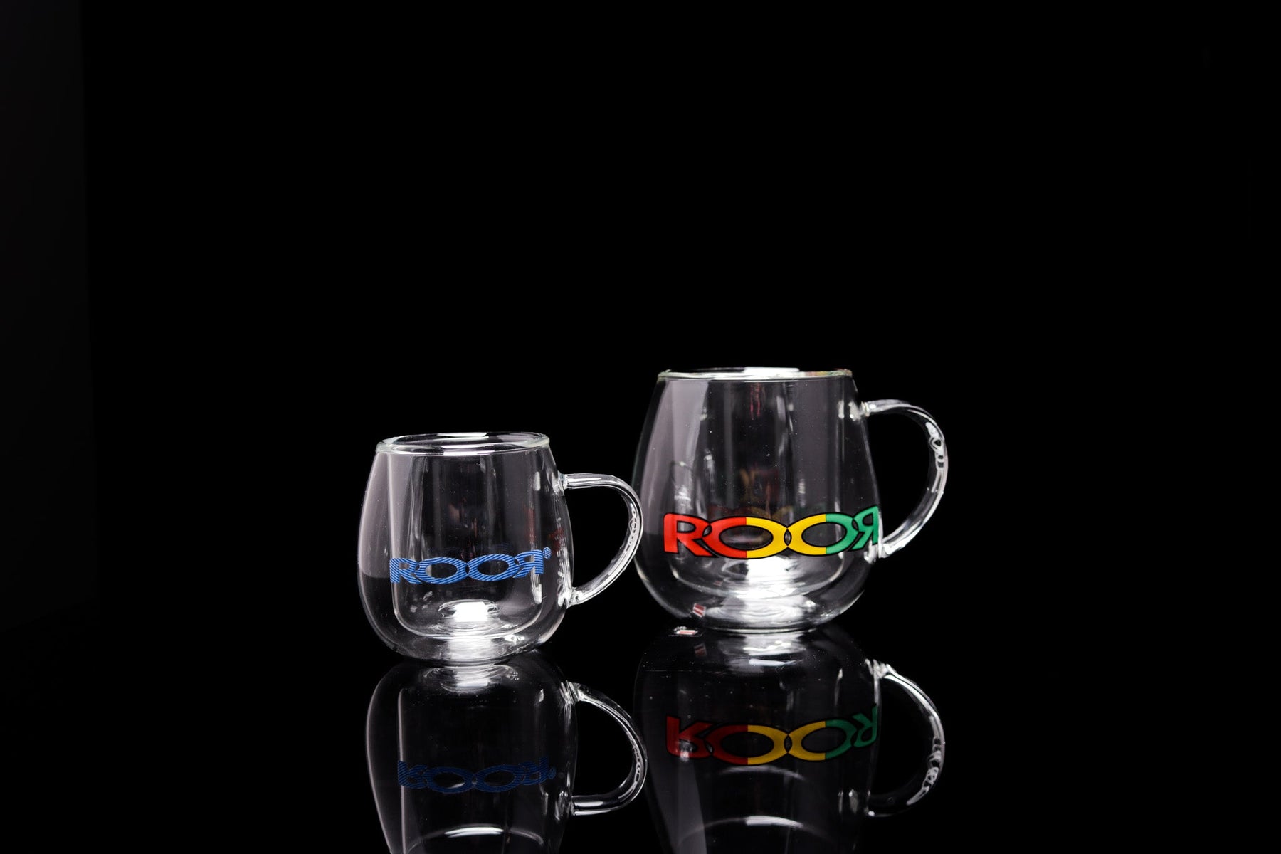 ROOR® Glass Mugs Double Layer with colorful decals on black background.