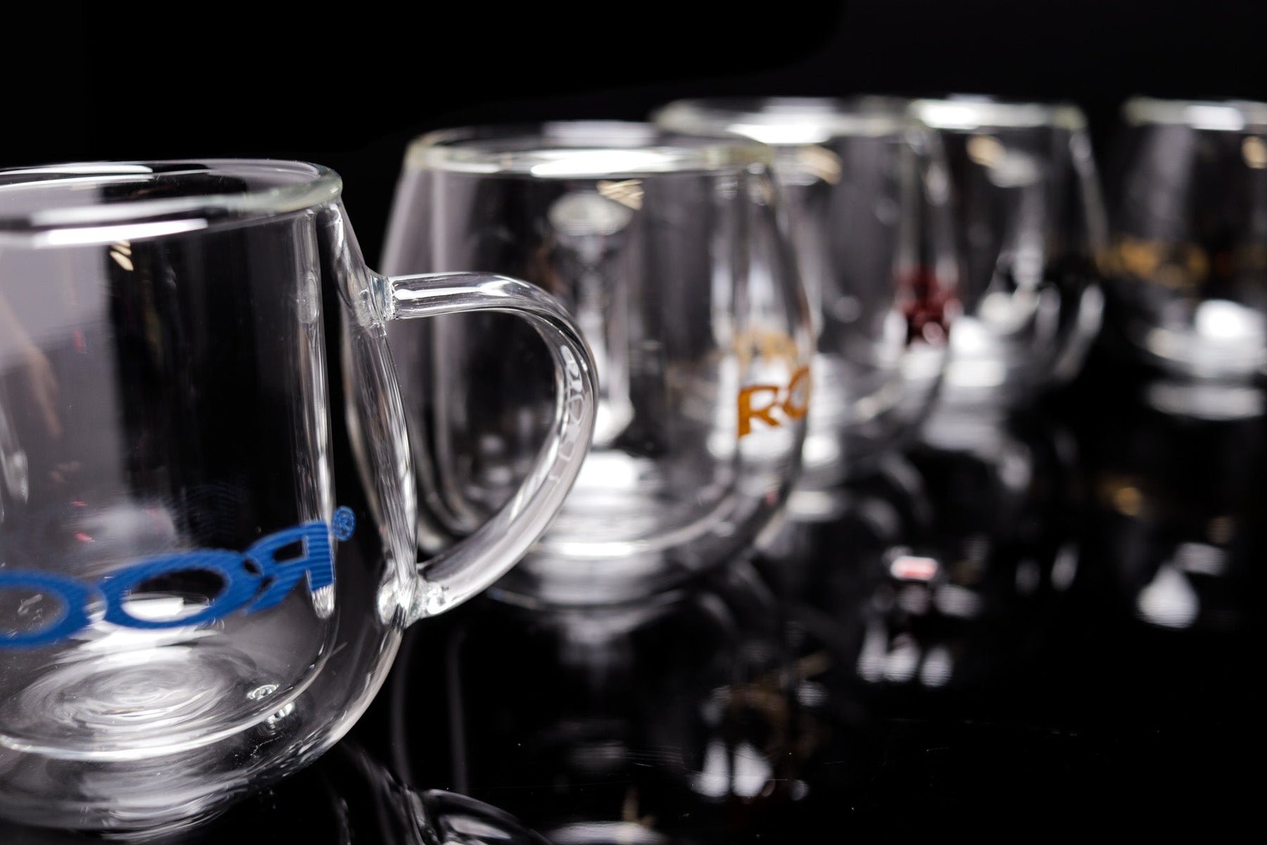 ROOR® Glass Mugs Double Layer with sleek transparent double walls on reflective surface.